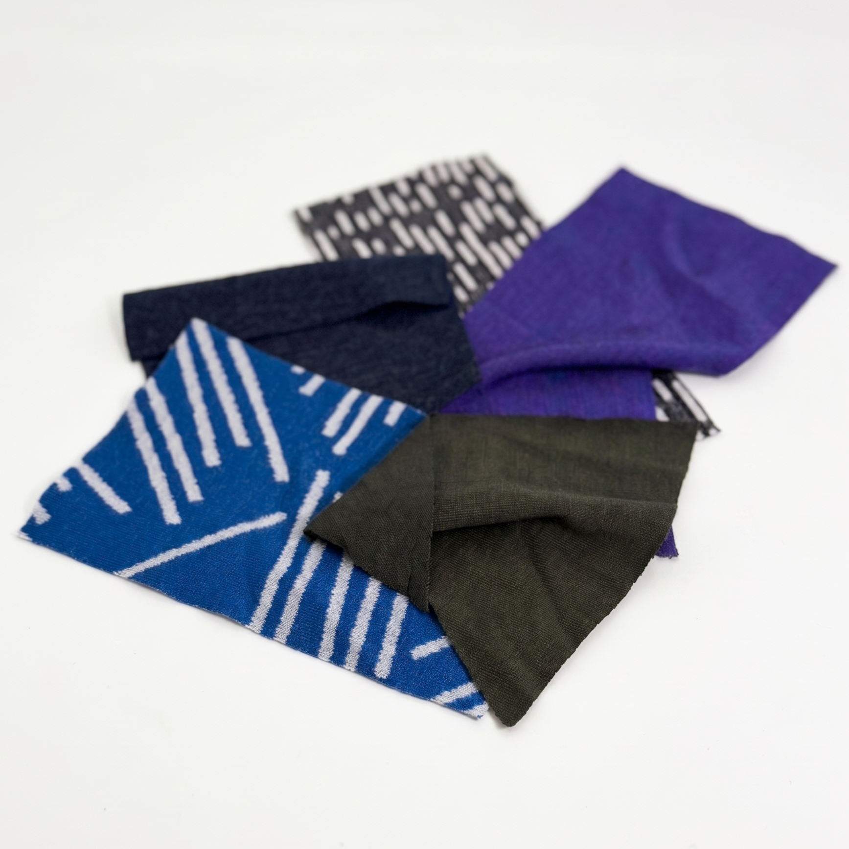 5 small fabric samples on a white background