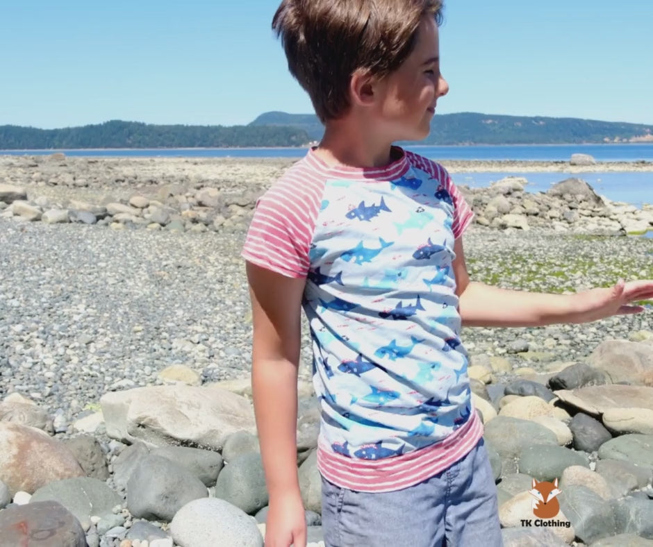 Boy moving freely and jiving to an unknown beat in a soft, lightweight custom organic cotton t-shirt made by TK Clothing.